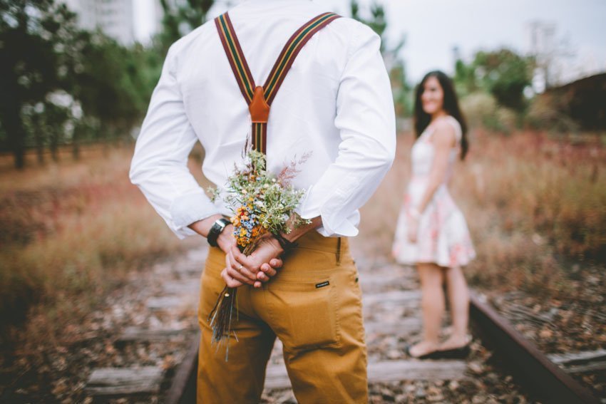 Man Surprising His Partner with Flowers
